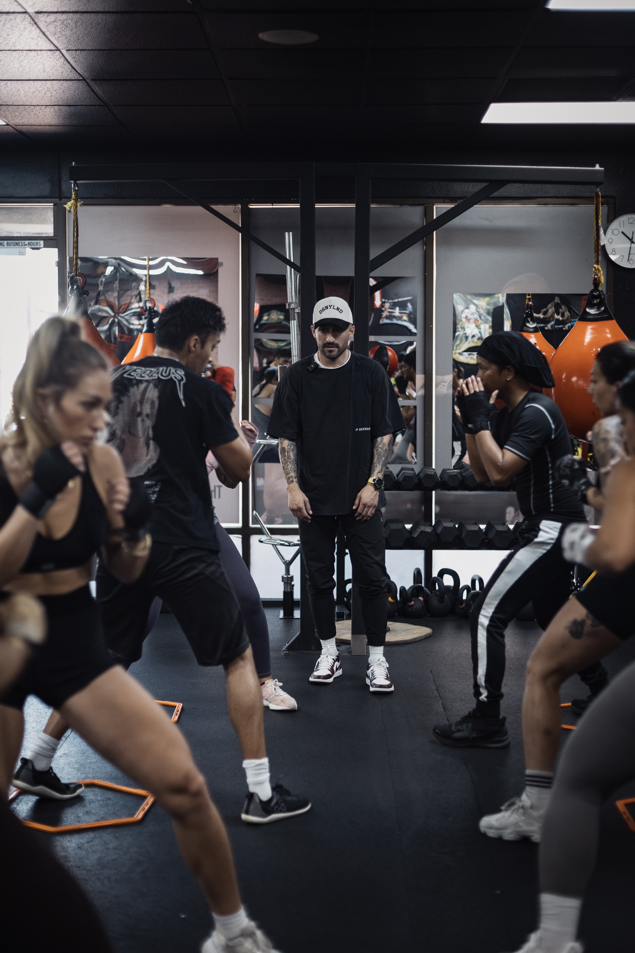 Coach watching athletes train during a boxing class